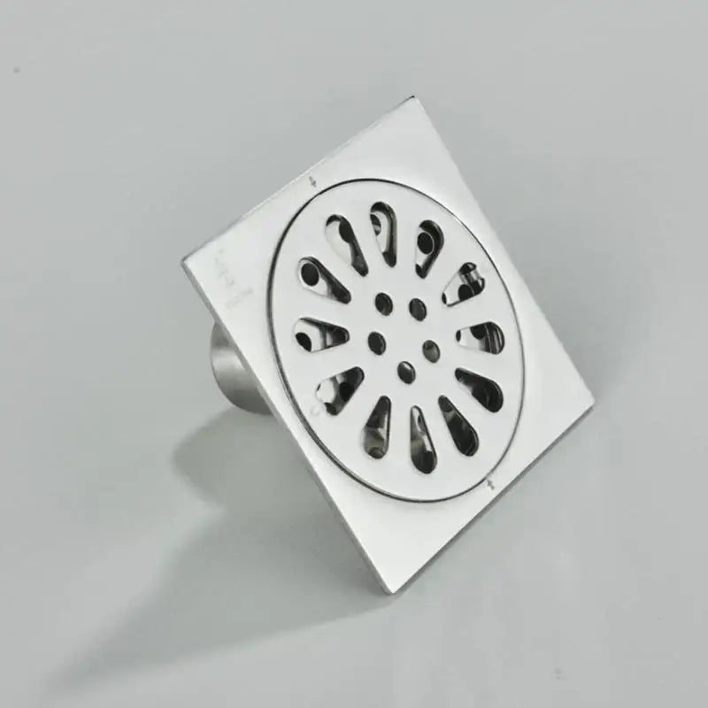 DecorBites™ antique brass square fish carved floor drain with chrome finish and circular petal patterned grate