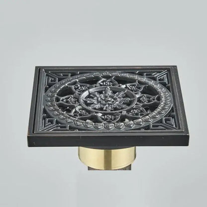 DecorBites antique brass floor drain with black matte finish and square fish carved floral embossed pattern on brass base