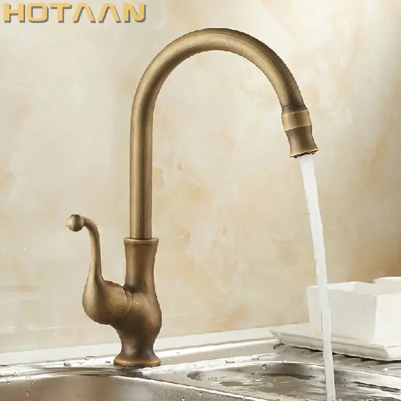 DecorBites antique brass swivel basin mixer tap with ornate swan-neck design and curved spout in brass finish