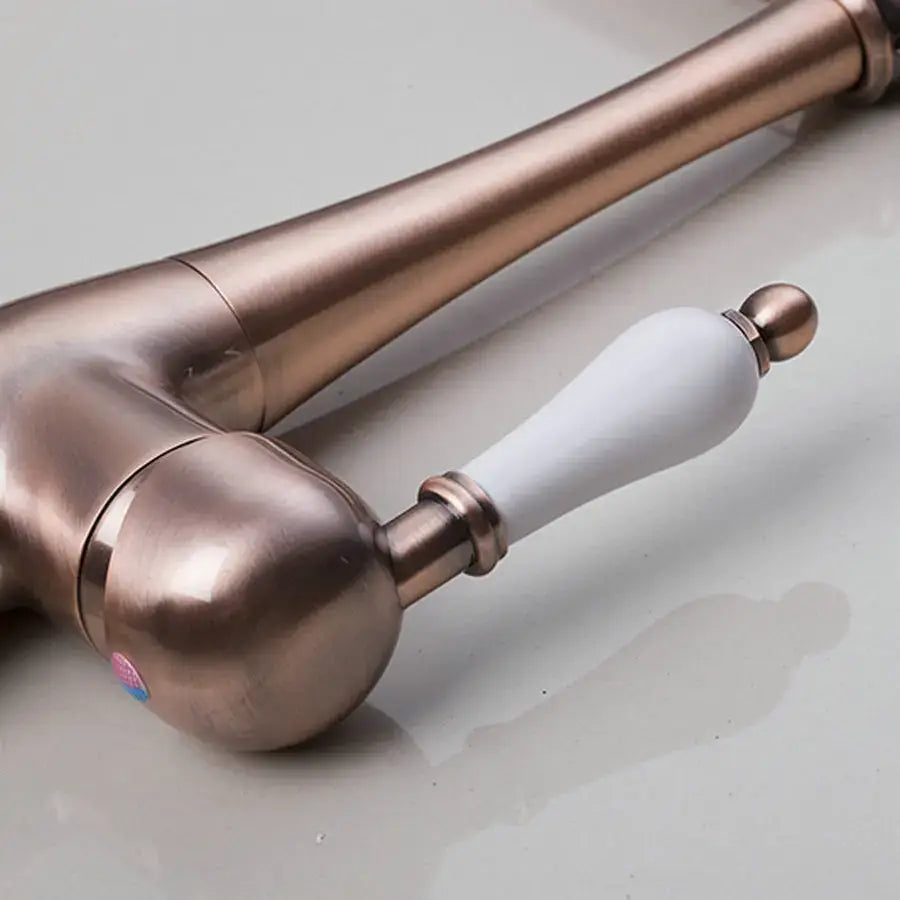 DecorBites™ antique brass kitchen faucet with ceramic handle and polished metal accents for countertop sink use