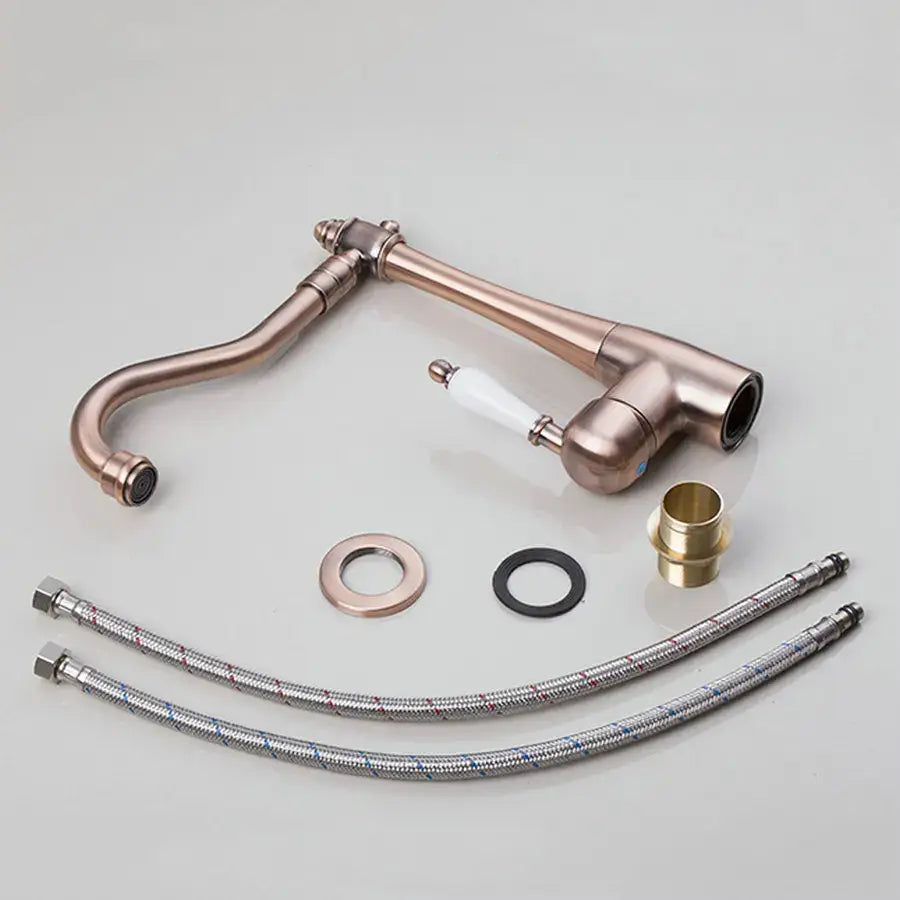 Decorbites™ antique brass swivel kitchen faucet with white ceramic handle and flexible metal hoses for countertop sink