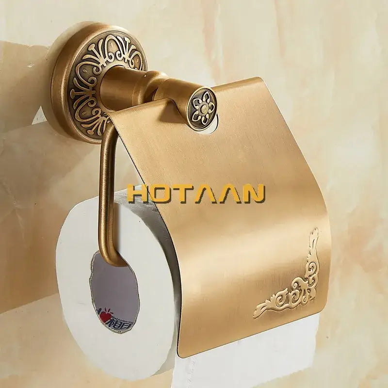 DecorBites antique brass toilet paper holder with ornate floral embossing and curved arm design for classic bathrooms