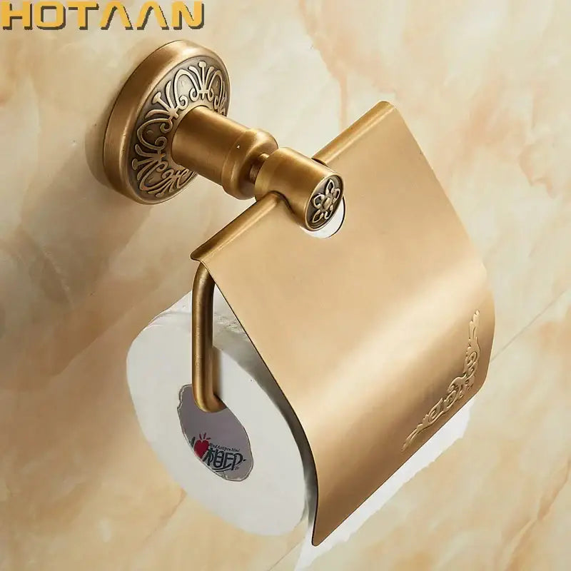 DecorBites™ antique brass toilet paper holder with ornate floral embossing and sleek curved design for classic bathrooms