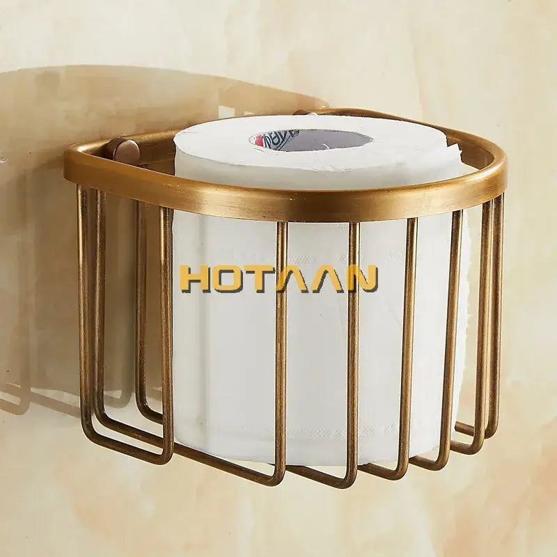 DecorBites™ antique brass toilet paper holder with gold-toned metal vertical bars cradling a white paper roll