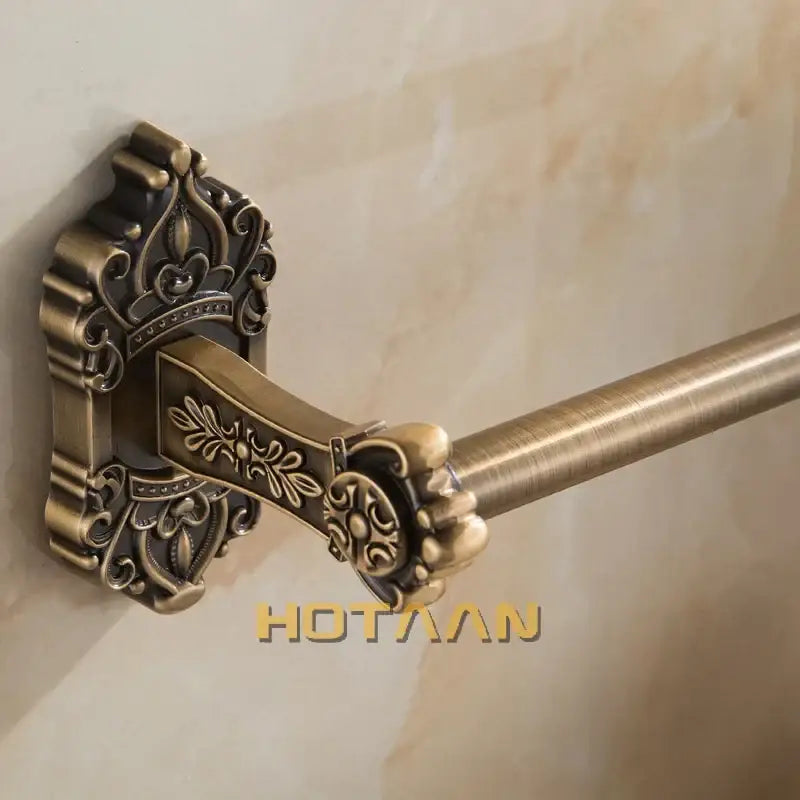 DecorBites™ antique brass towel bar with ornate crown-inspired wall mount and floral detailing for bathroom use