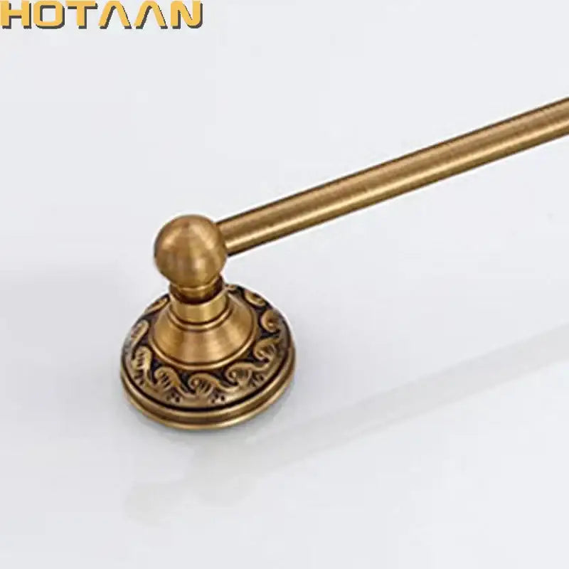 Antique brass towel holder single bar with ornate scrollwork on circular base made of solid aluminium by decorbites