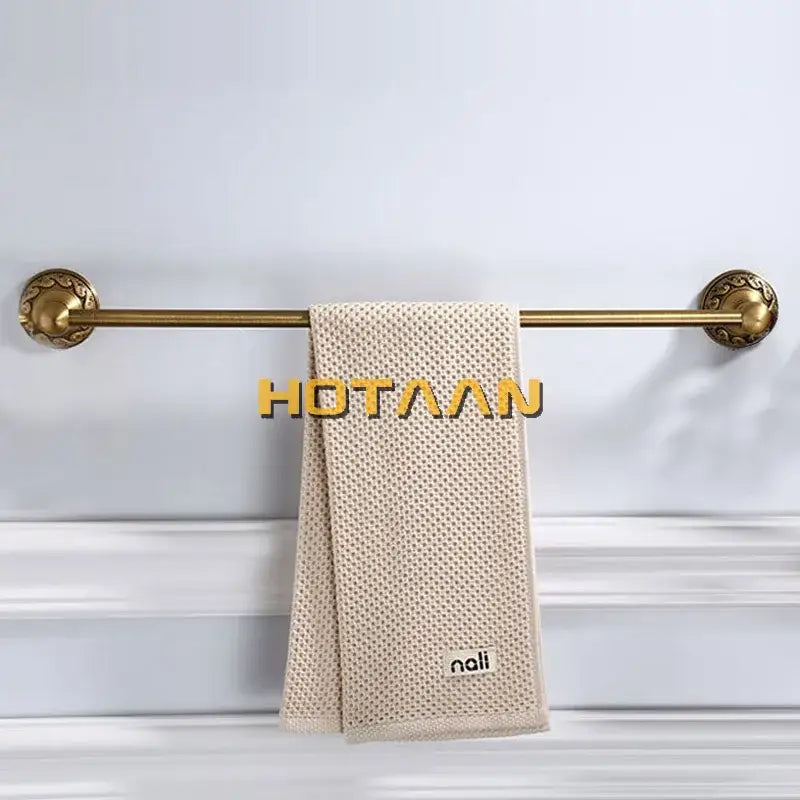 Beige textured towel hanging on DecorBites™ antique brass single bar towel holder made of solid aluminium