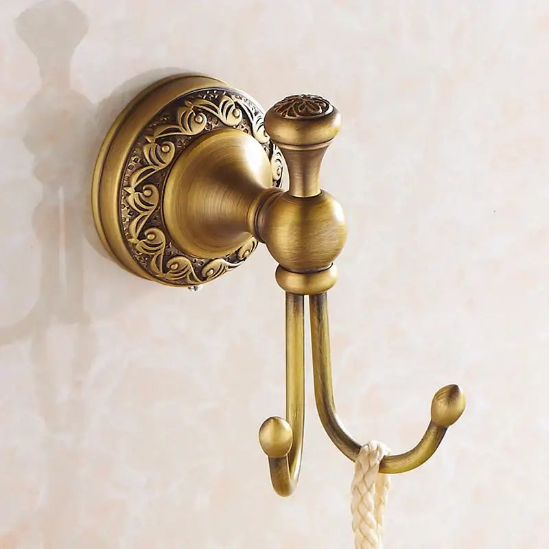 DecorBites antique brass towel hooks wall rack with ornate scrollwork and rope hanging from the lower hook