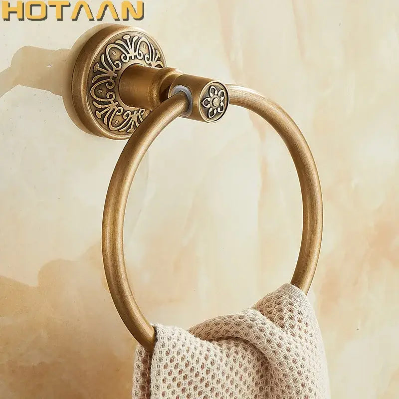 DecorBites™ antique brass towel ring with ornate floral mounting plate and circular hoop for bathroom use