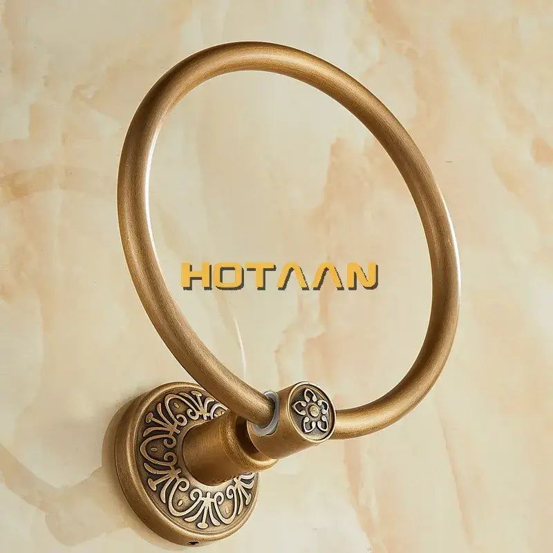 DecorBites™ antique brass towel ring with ornate floral detailing on the mounting plate for bathroom use