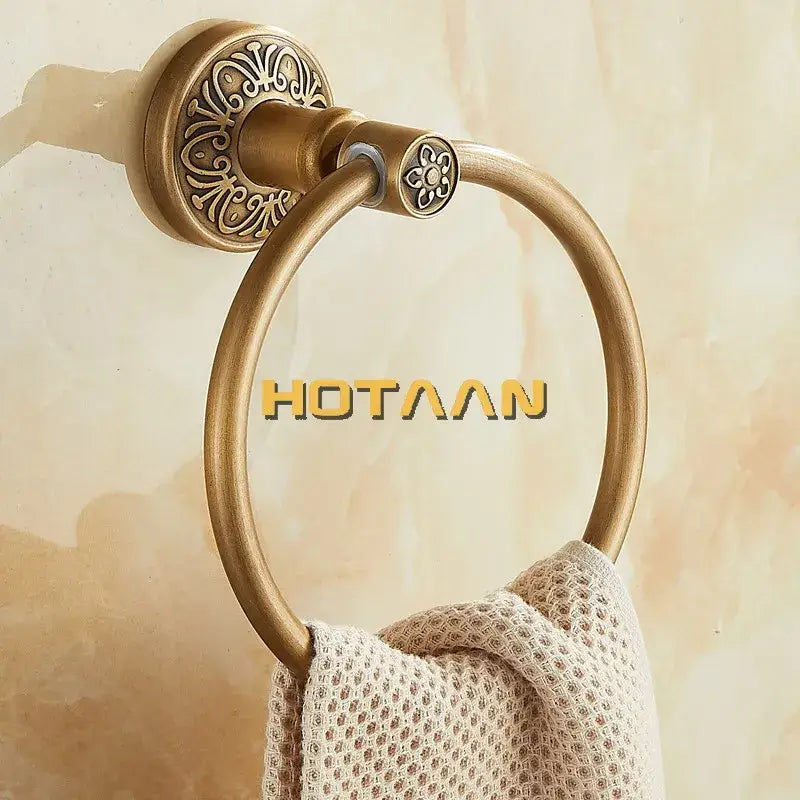 Decorbites antique brass towel ring with ornate floral mounting plate and circular hoop for bathroom wall mounting