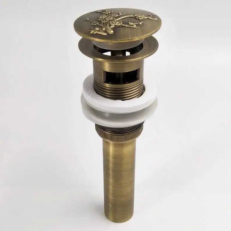 DecorBites antique brass vessel sink drain with floral engraved top and white ceramic washer for bathroom use