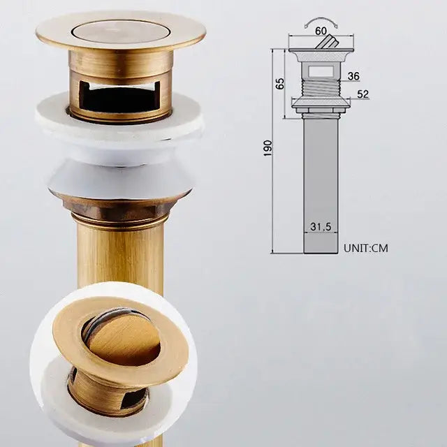 Brass-colored antique brass vessel sink drain strainer with white ceramic flange and circular pop up stopper for lavatory basin