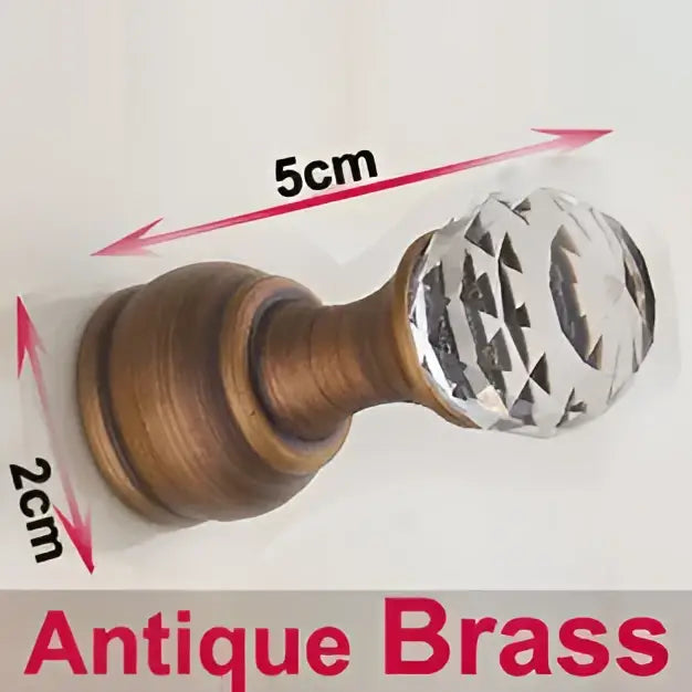 Antique brass wall clothes rack featuring a faceted crystal knob and antique brass curtain rod holder for bathroom use