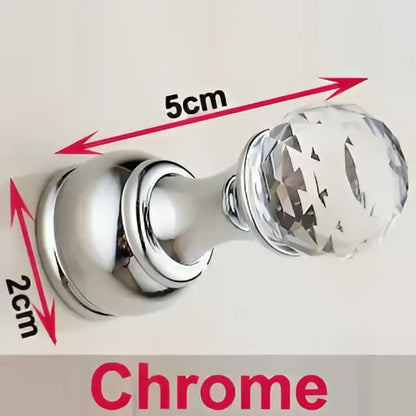 Chrome-finished crystal knob with faceted transparent head and polished base on decorbites antique brass wall clothes rack