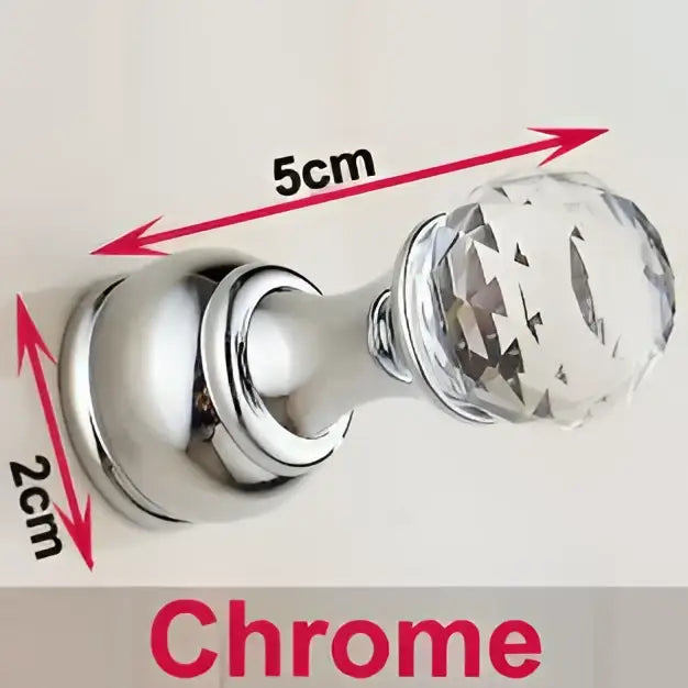 Chrome-finished crystal knob with faceted transparent head and polished base on decorbites antique brass wall clothes rack