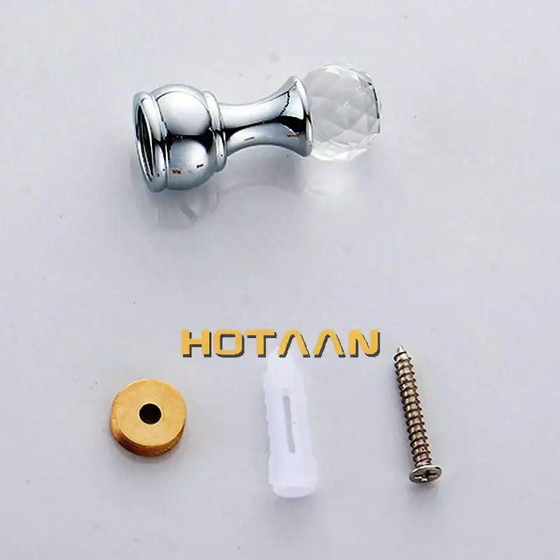 Chrome-finished cabinet knob with faceted clear crystal head on DecorBites antique brass wall clothes rack bathroom accessory hanger