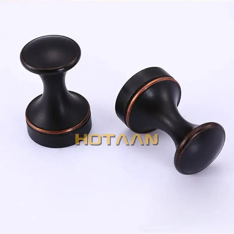 Decorbites™ antique brass wall robe hanger with black matte cabinet knobs and copper-toned accent rings