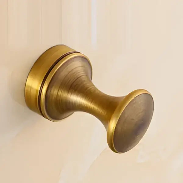 DecorBites antique brass wall clothes rack hook with tapered design for use as a robe hanger in bathrooms