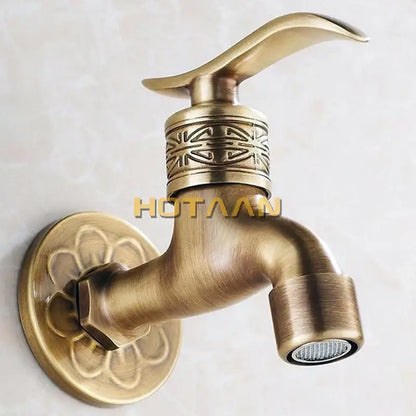 Decorbites antique brass wall mount bathroom faucet with ornate floral and geometric embossing on base plate and handle collar