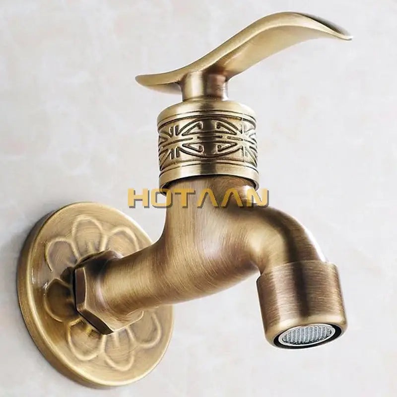 Decorbites antique brass wall mount bathroom faucet with ornate floral and geometric embossing on base plate and handle collar