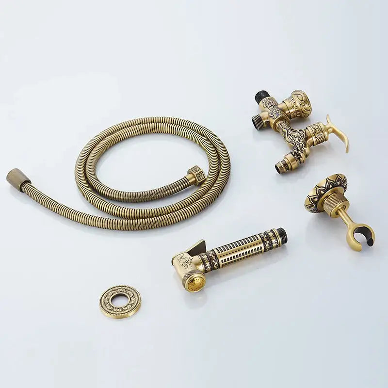 Decorbites antique brass wall mount bidet faucet set with ornate detailing and coiled hose for hygienic bathroom use