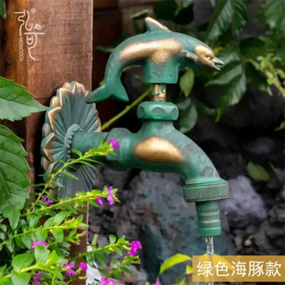 DecorBites™ antique brass wall mount garden faucet with green dolphin design and decorative shell brass accents