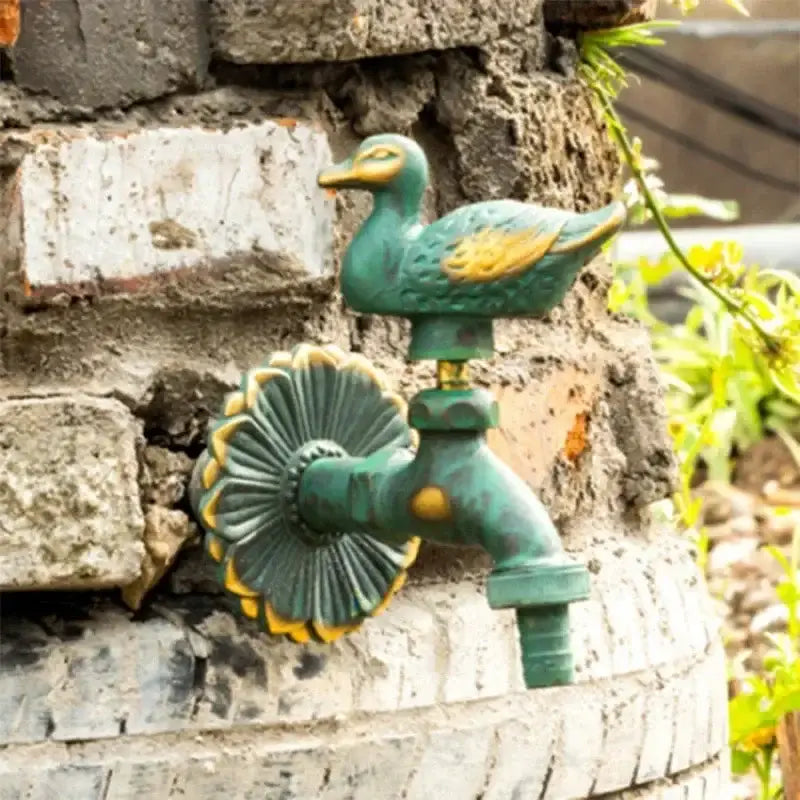 DecorBites antique brass wall mount garden faucet in green and gold duck design with sunburst base for kindergarden use