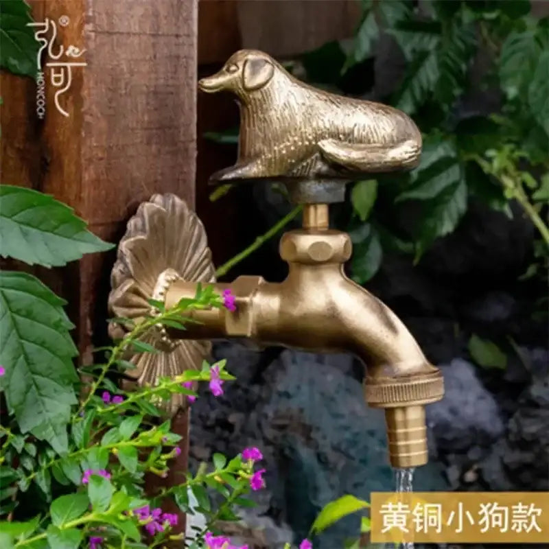 DecorBites™ antique brass wall mount garden faucet with detailed dog figurine cap and ornate fluted design