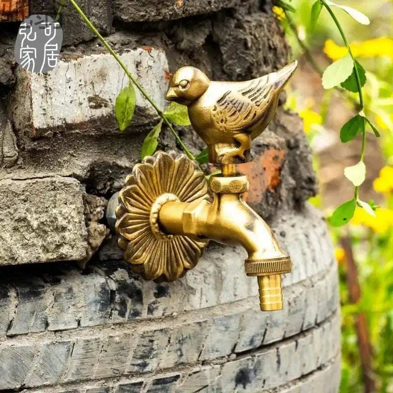Decorbites antique brass wall mount garden faucet featuring a golden bird-themed brass outdoor spout with floral design