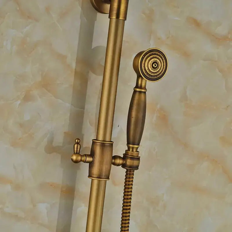Antique brass wall mount shower faucet with matching handheld nozzle, decorative control knob, and 8 inch rain shower head