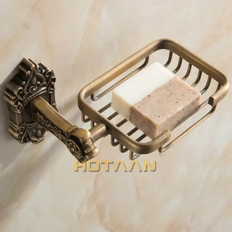 Decorbites antique brass wall mount soap basket with ornate wire mesh design holding two bars of soap