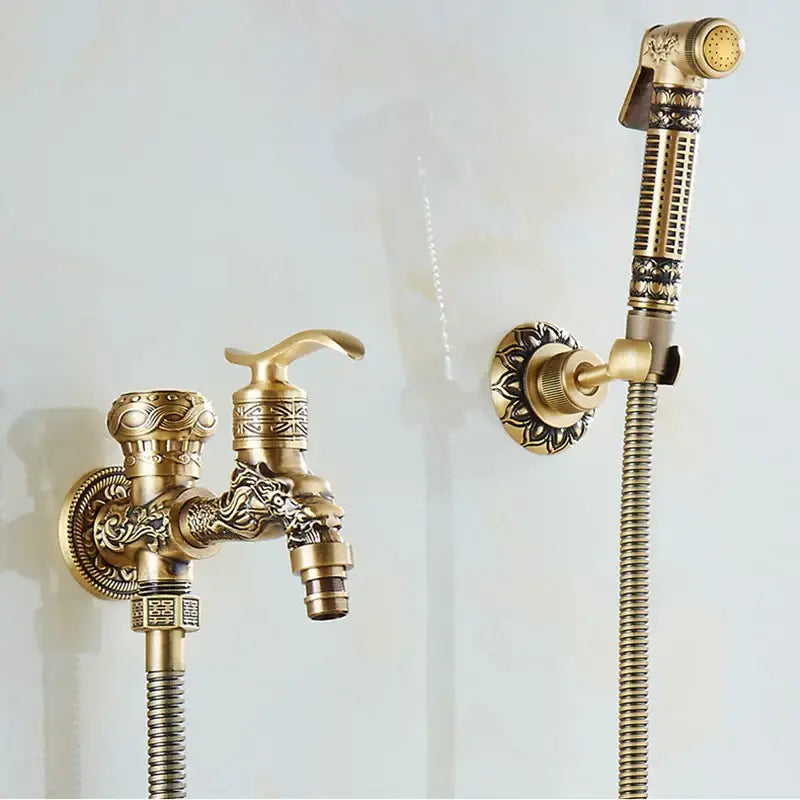 Decorbites™ antique brass wall mounted bidet faucet with ornate dragon head design and matching handheld showerhead