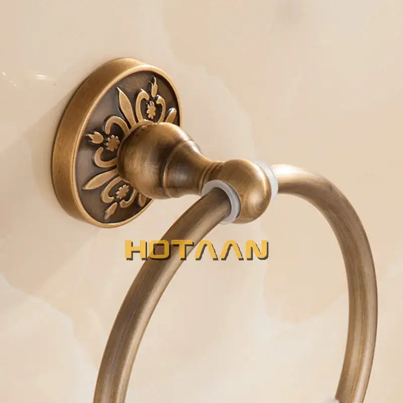 DecorBites antique brass round towel holder with ornate floral engraving on mounting plate for classic bathroom use