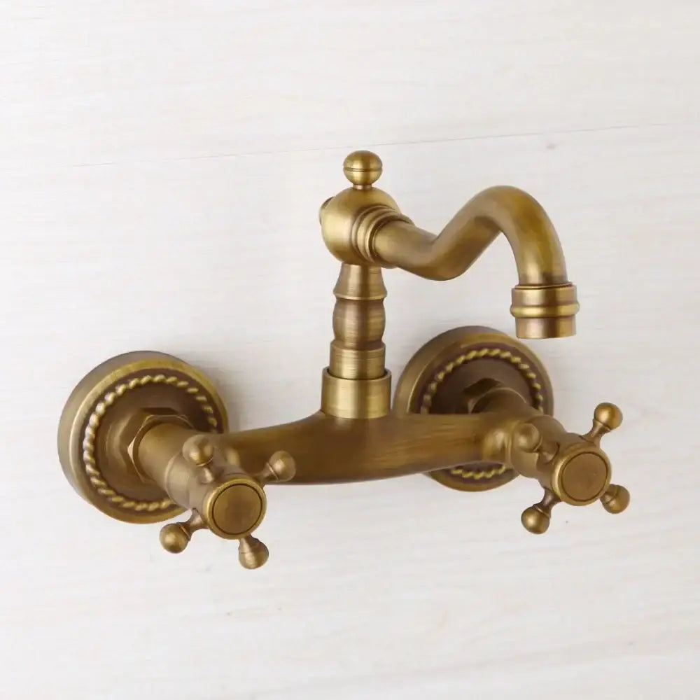 Antique brass wall mounted shower faucet with double handles and ornate rope-textured escutcheons by DecorBites