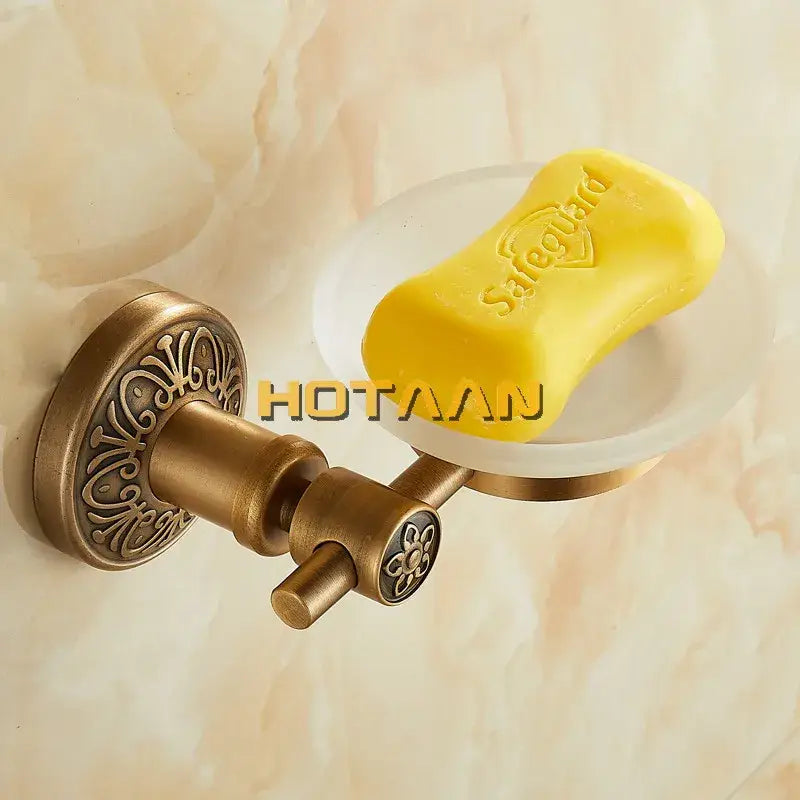 DecorBites antique brass wall mounted soap dish with ornate floral detailing holding a yellow Safeguard soap bar