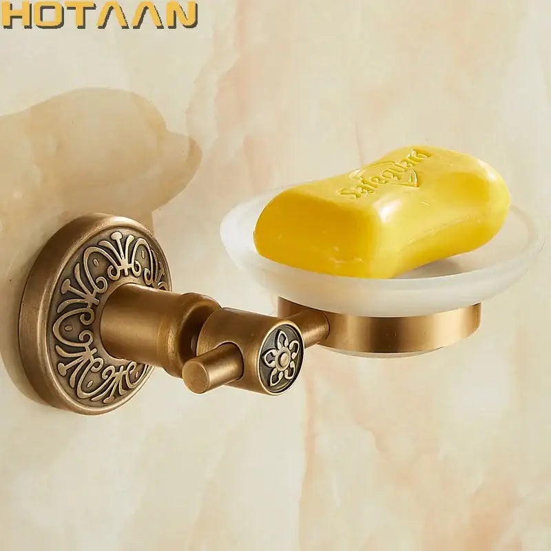 DecorBites™ antique brass wall mounted soap dish with ornate floral detailing and white ceramic bowl holding yellow soap
