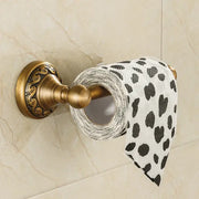 DecorBites™ antique brass toilet paper holder with ornate scrollwork holding white tissue paper with black heart leopard print