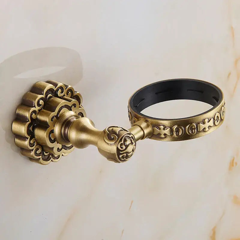 Decorbites antique brass wall mounted toothbrush holder with ornate brass towel ring and black rubber interior detail