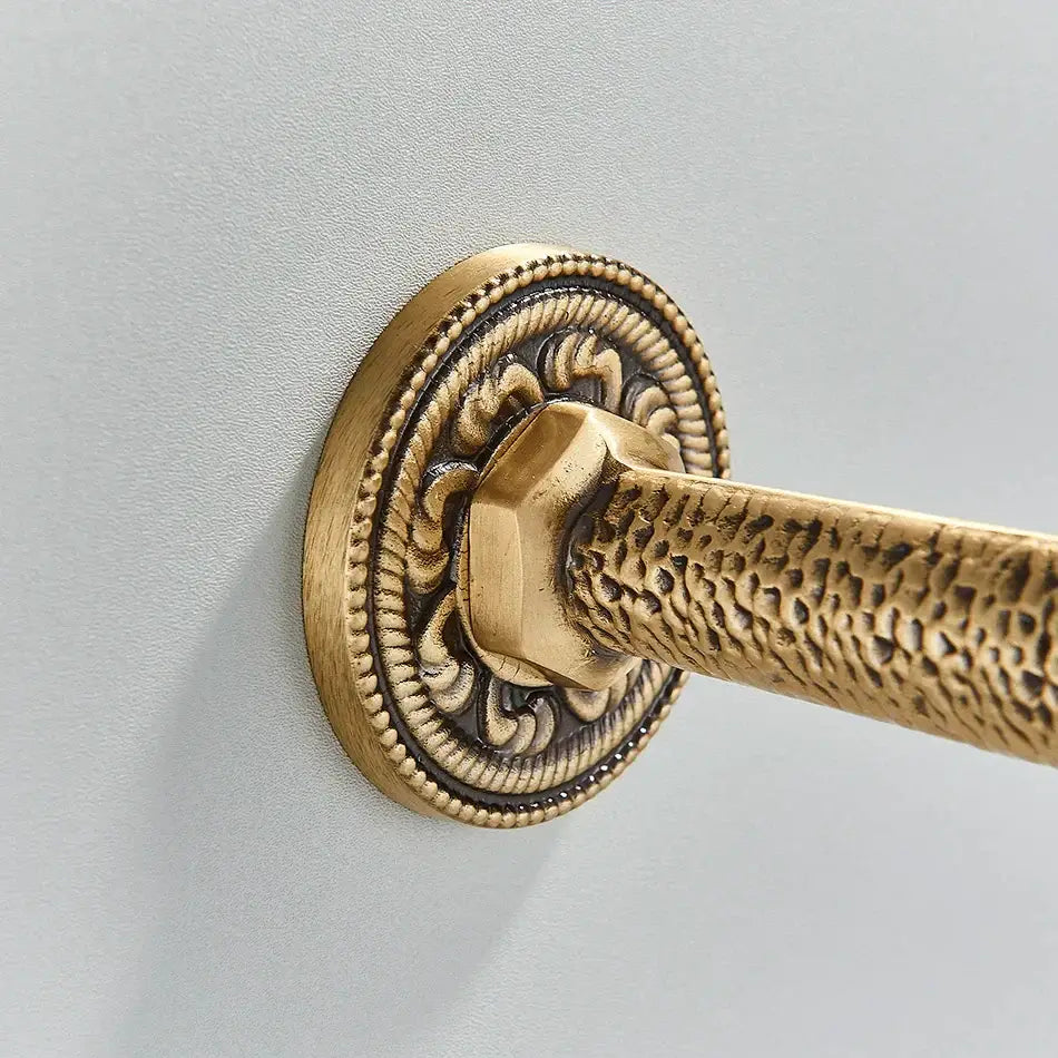 DecorBites™ antique brass wall mounted washing machine faucet with ornate textured circular plate and hammered brass rod
