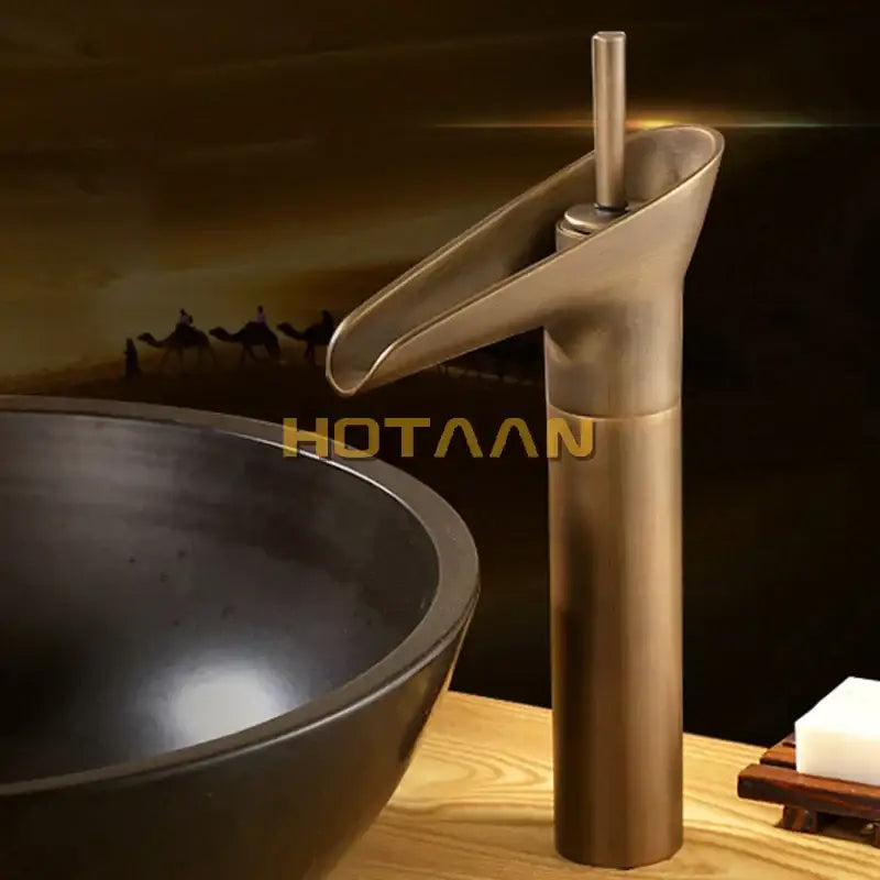 DecorBites antique brass waterfall basin faucet mixer tap with sleek curved spout and cylindrical base for bathroom sink