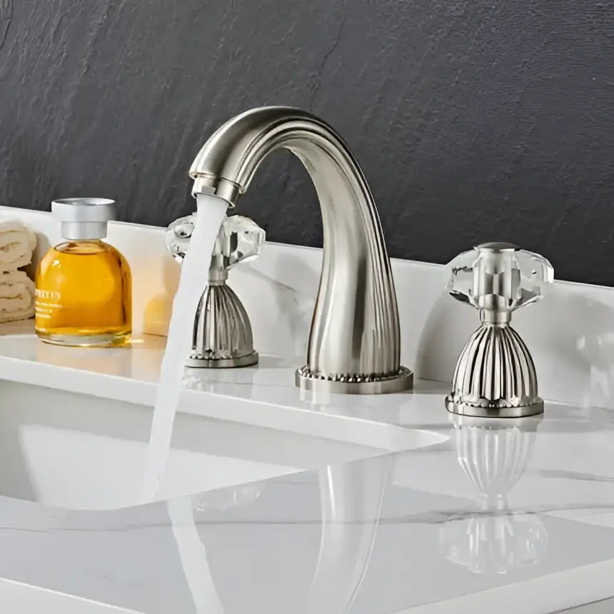 Stainless steel basin faucet with crystal knobs and curved spout in décorBites™ antique bronze 3 hole widespread basin design