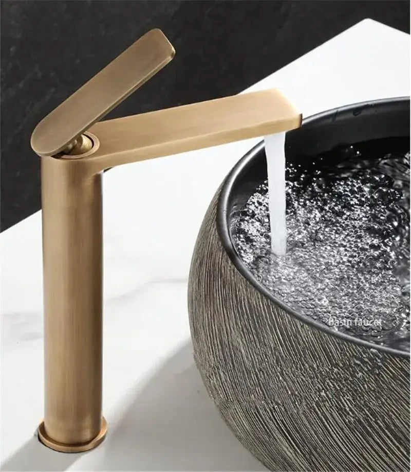 Modern brass-finished antique bronze basin faucet with sleek minimalist design for bathroom sink deck mounting