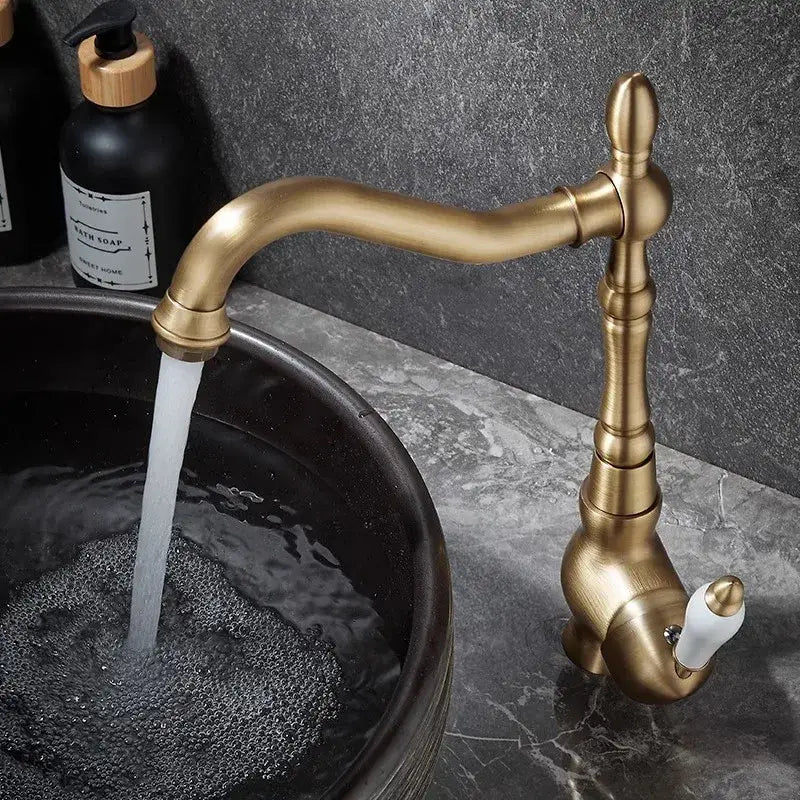 Decorbites™ antique bronze basin faucet with curved spout and ornate segmented body for kitchen and bathroom use
