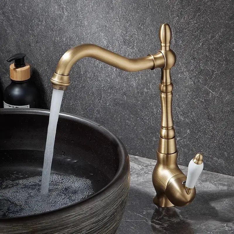 Antique bronze basin faucet with curved spout and white ceramic handle for bathroom and kitchen use by decorbites