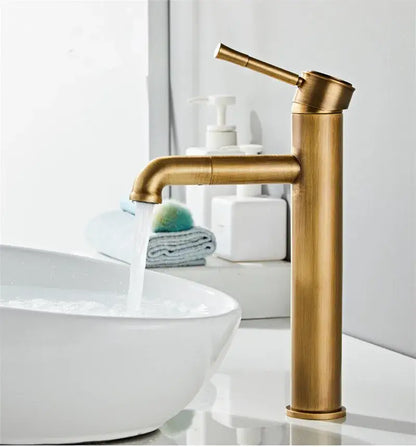 Brass-finished DecorBites™ antique bronze basin faucet with sleek cylindrical body and curved spout for deck mounting