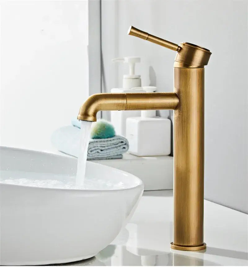 Brass-finished DecorBites™ antique bronze basin faucet with sleek cylindrical body and curved spout for deck mounting