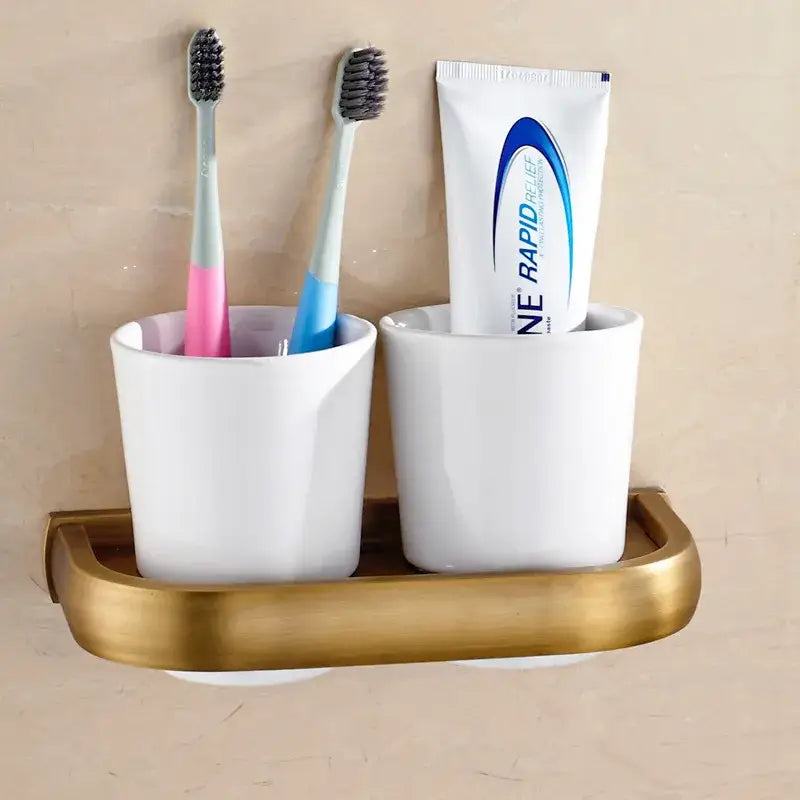 White ceramic toothbrush holder with gold-toned metal base from decorbites antique bronze bathroom accessory set