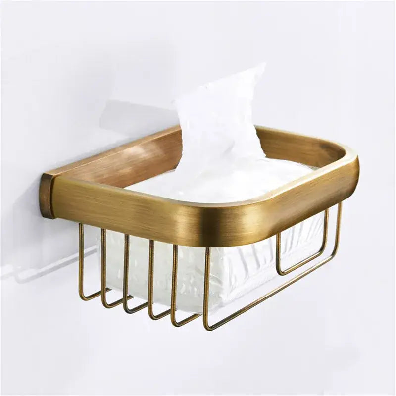 Brass-toned metal tissue box holder with wire mesh and curved edges in decorbites antique bronze bathroom accessory set