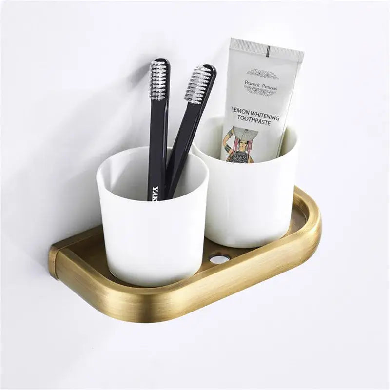 Decorbites™ antique bronze bathroom accessory set featuring a brass toothbrush and toothpaste holder with white ceramic cups